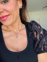 Black Camellia necklace in gold on mama card