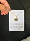 Black Camellia necklace in gold on mama card